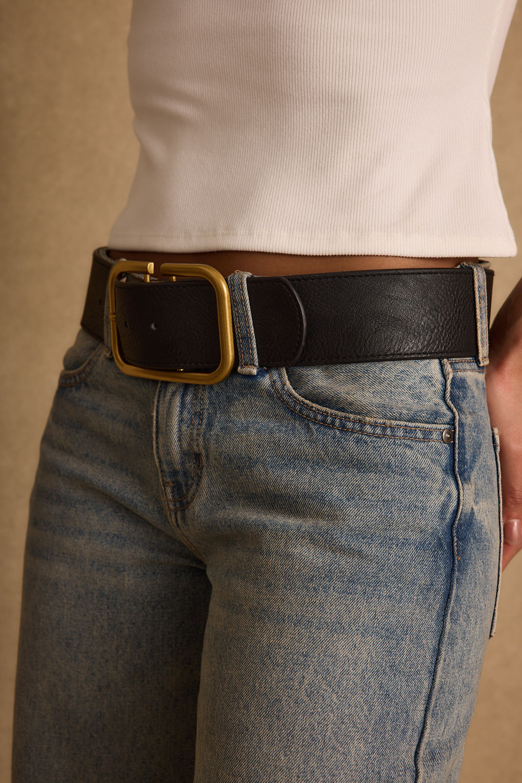 Oro Black and Gold Belt shown as part of a styled outfit ensemble.