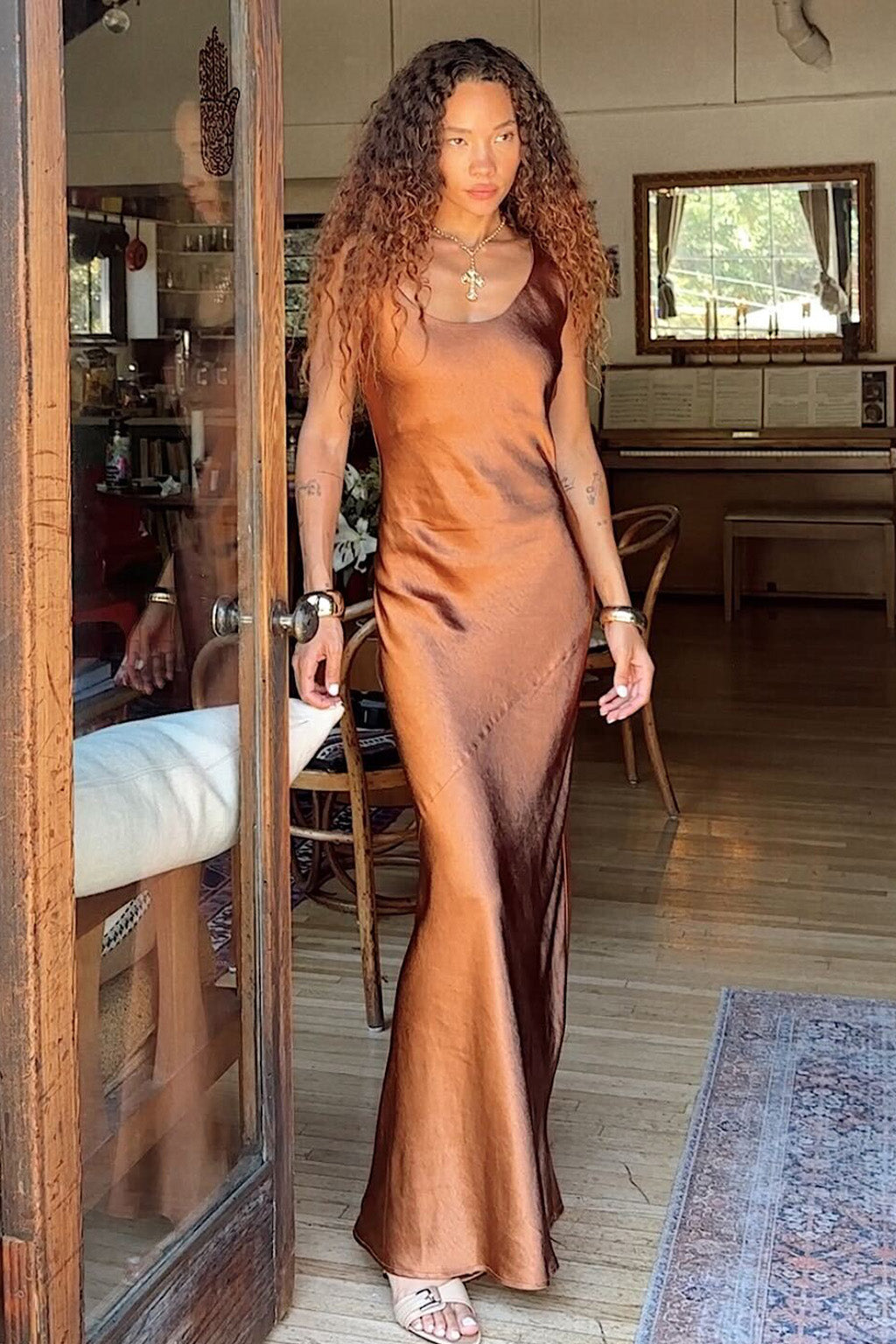 Alternate angle of the bronze maxi dress highlighting the overall design.