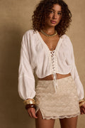 White lace top with refined accents, a white lace skirt essential.