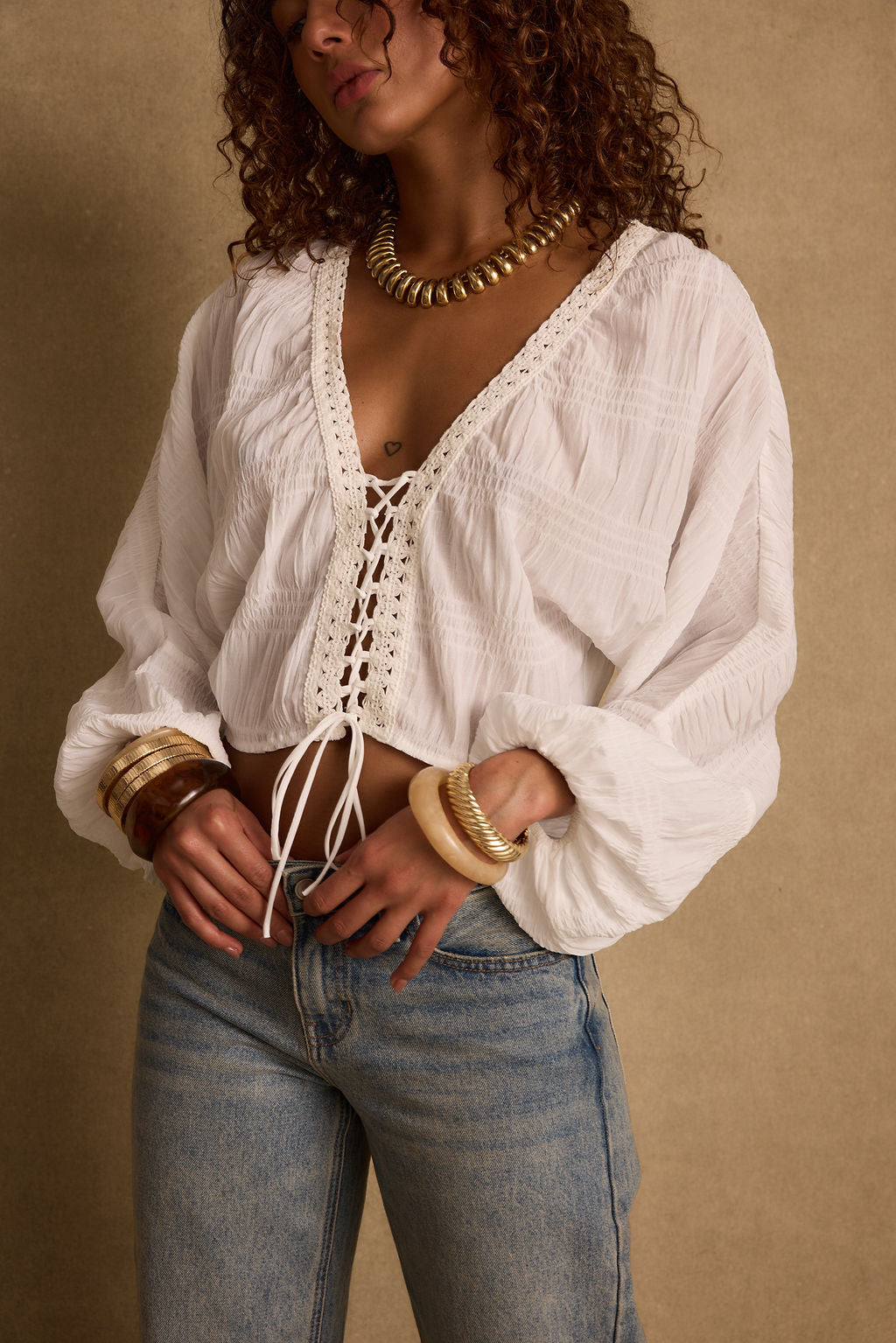 Detail shot of the Rainey White Lace Up Top highlighting the lace elements.