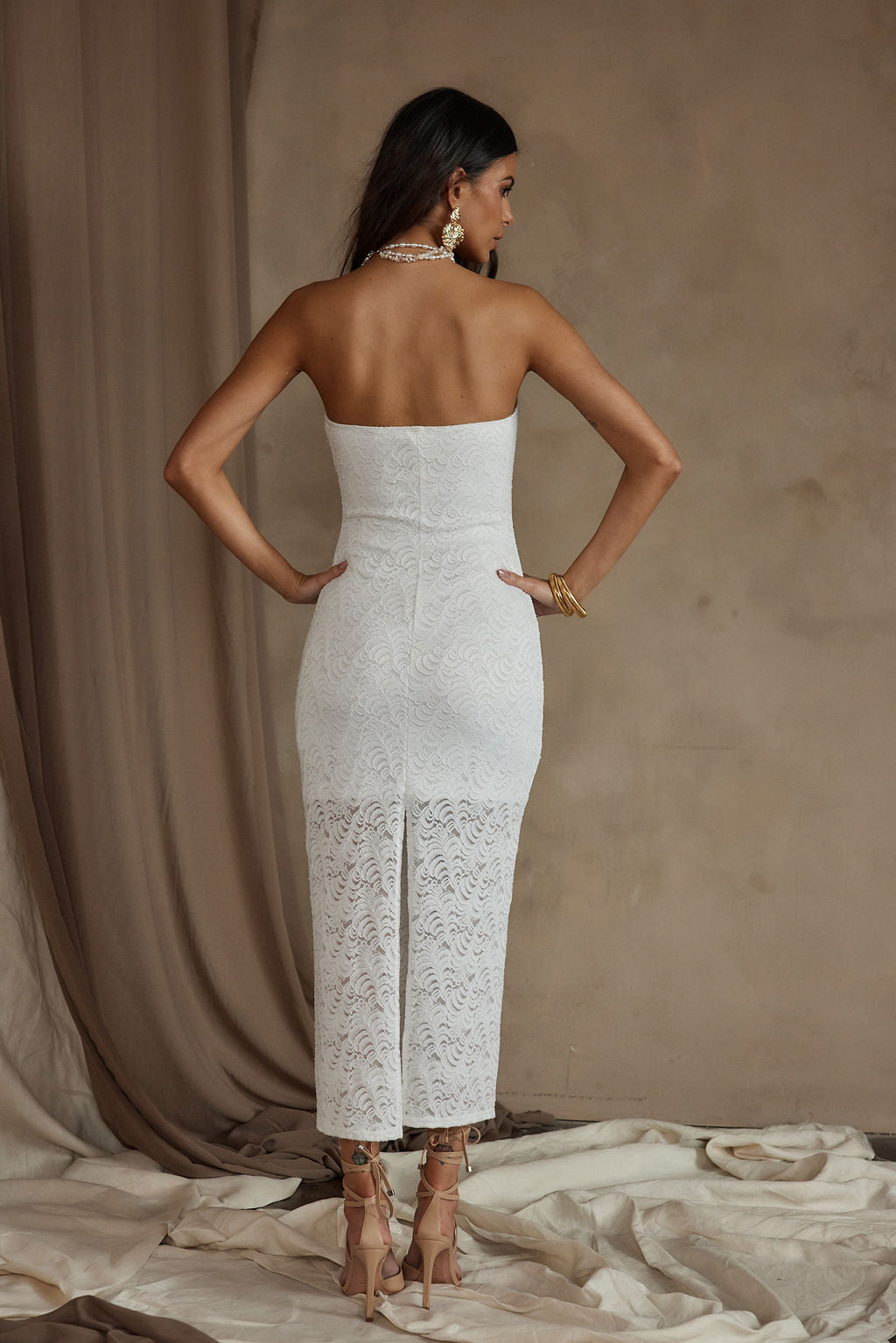 Reagan Strapless White Lace Midi Dress paired with complementary accessories for a polished look.
