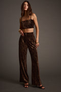Espresso velvet trousers with refined detailing and a flattering silhouette.