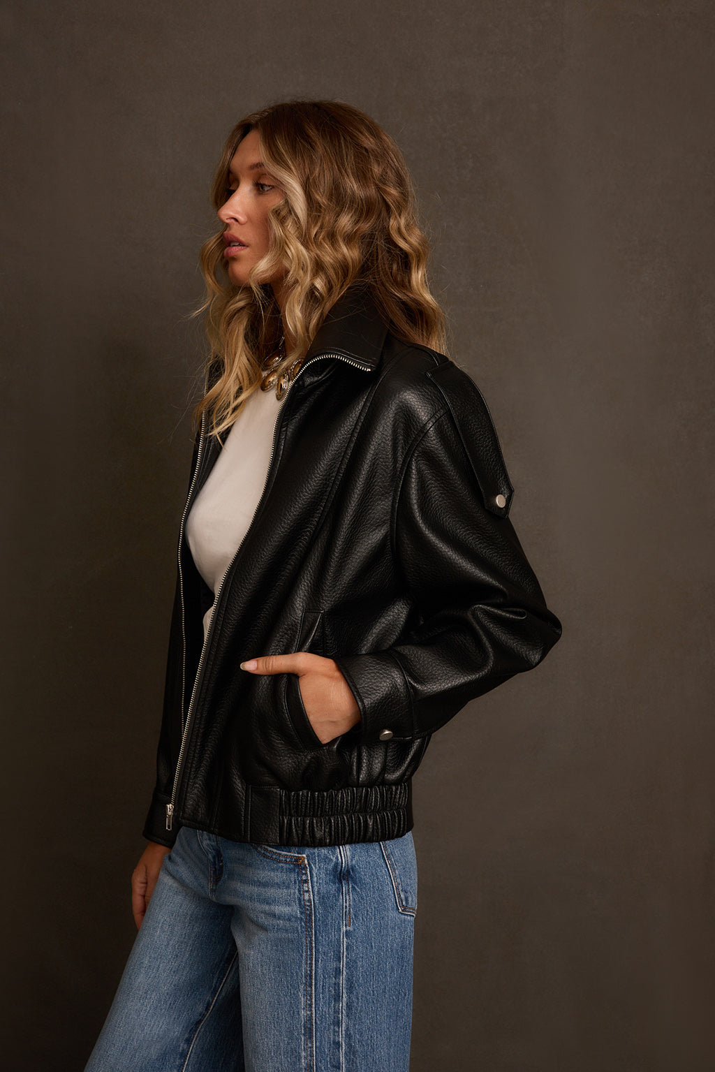 Faux leather jacket side view, oversized relaxed fit with dropped shoulders