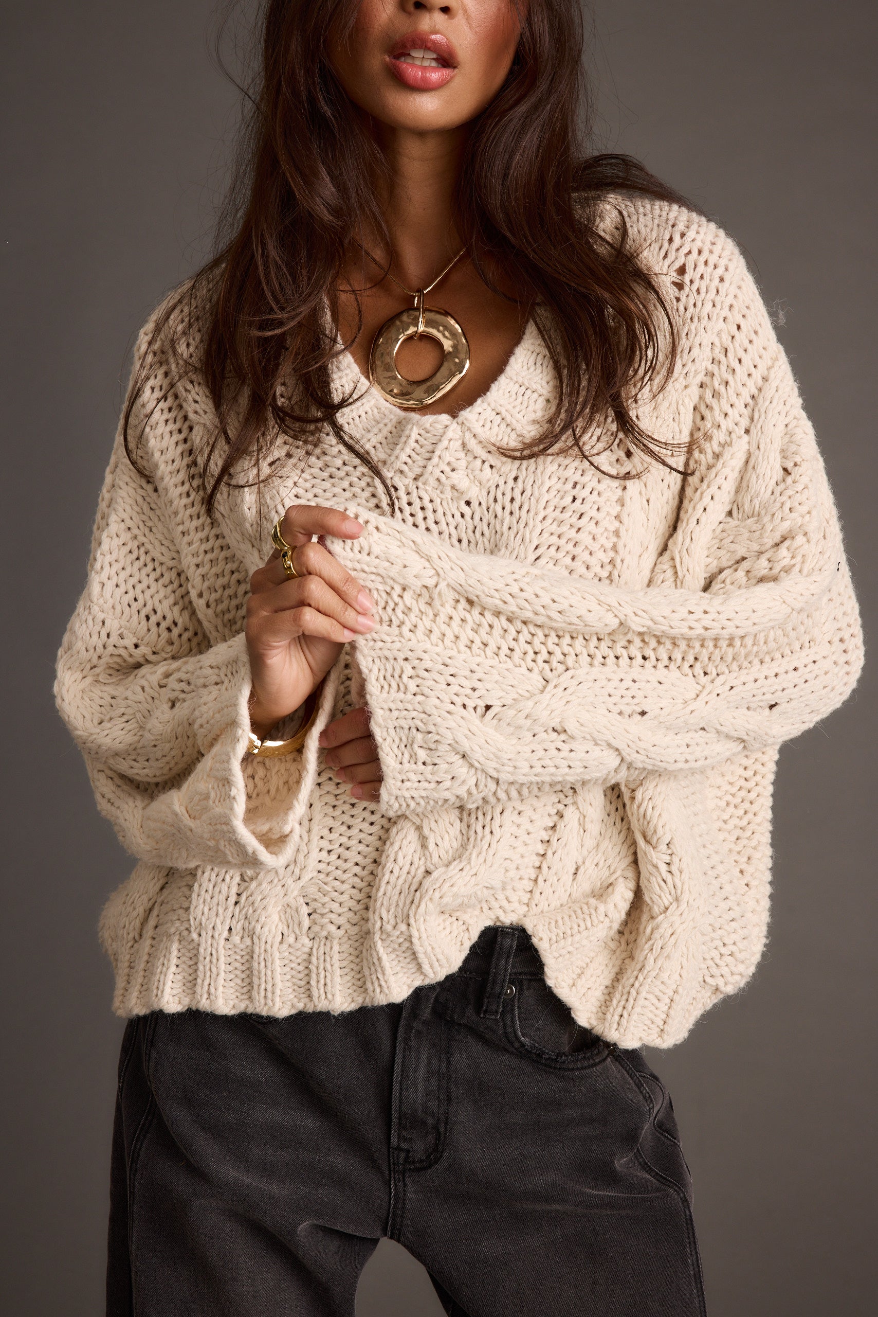 Remi Ivory Cable Knit Sweater paired with complementary accessories for a polished look.