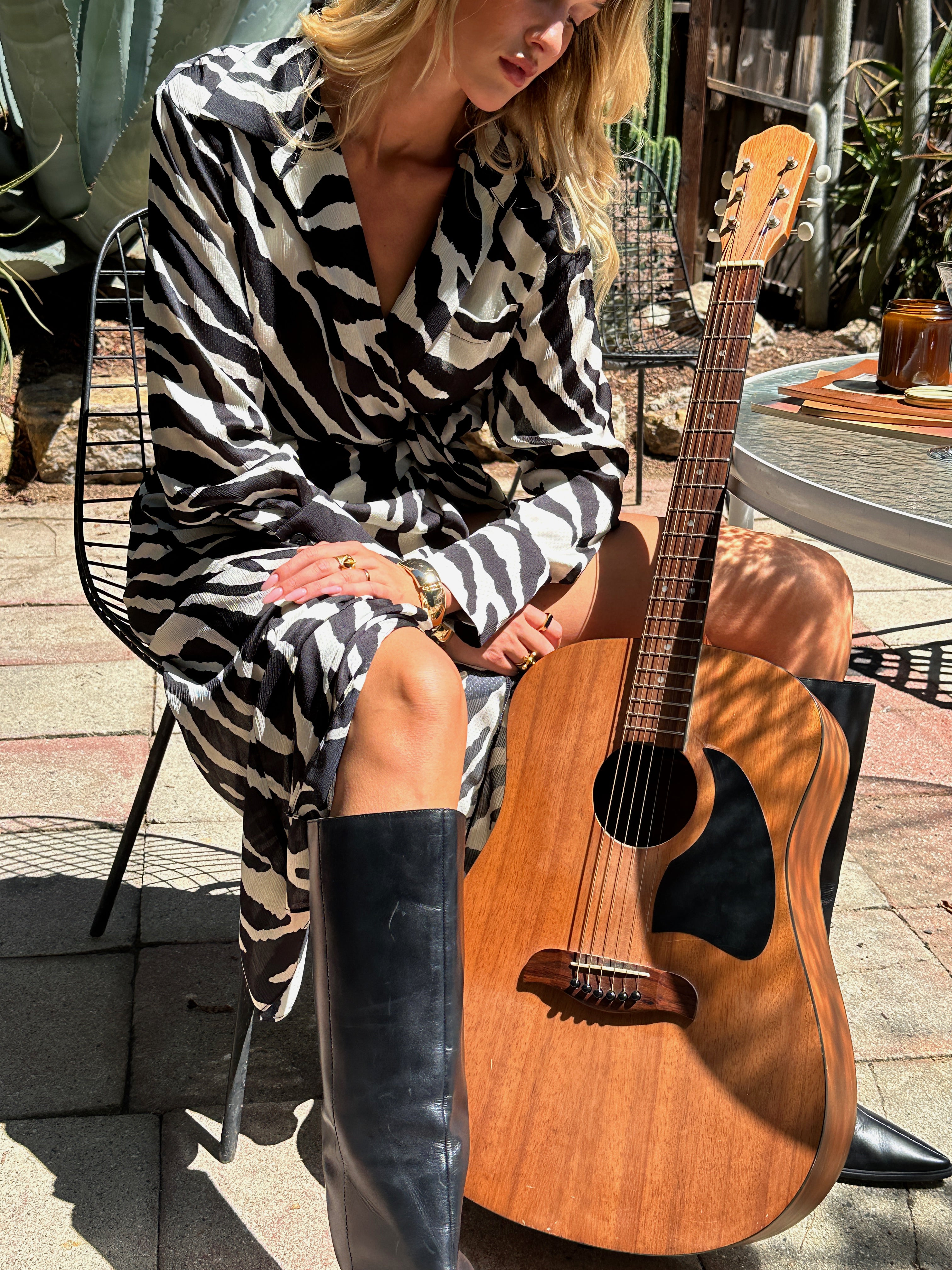 Lifestyle shot of the zebra print midi dress styled for day-to-night versatility.