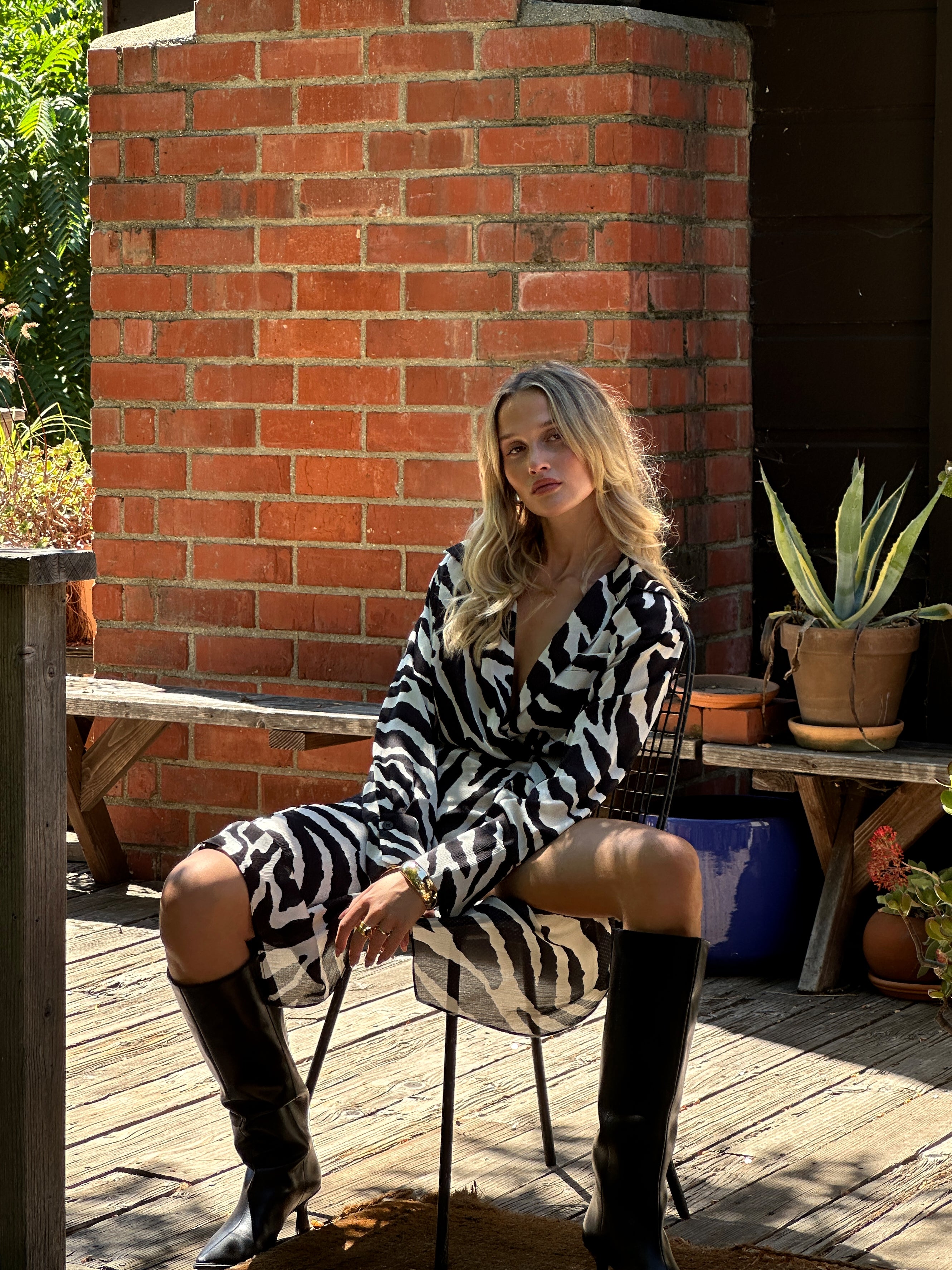 Alternate angle of the zebra print midi dress highlighting the overall design.