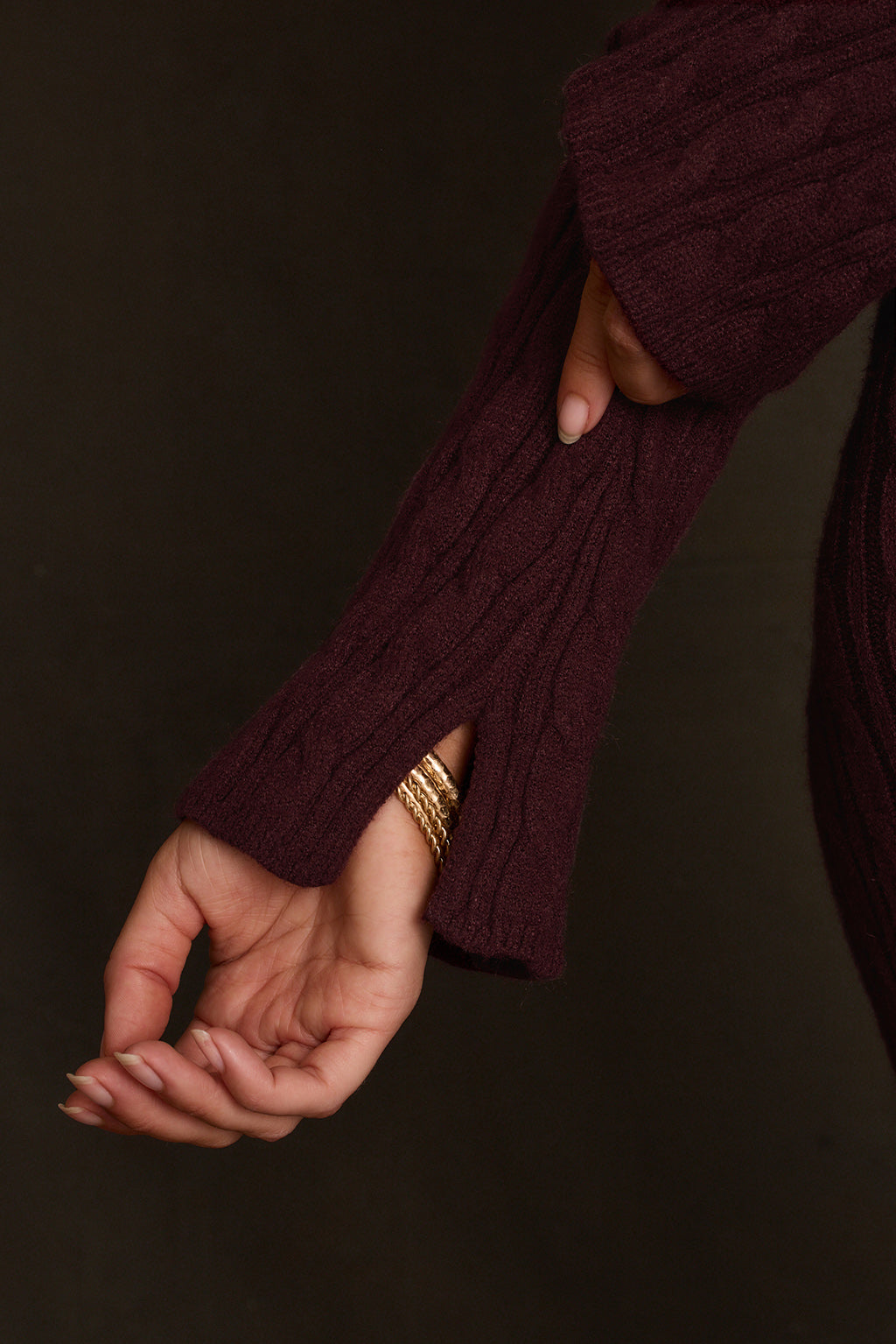 Maxi sweater dress styled with black ankle strap heels, studio shot three-quarter angle