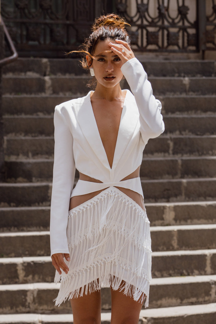 Back view of the white fringe and lace dress showing the silhouette and fit.