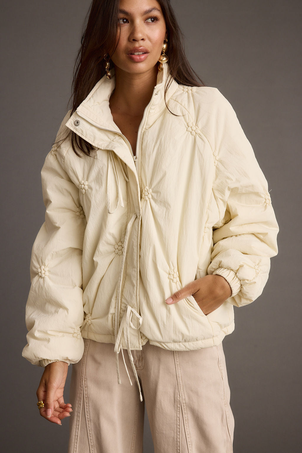Close-up of the Rosey Cream Zip Front Puffer Coat showcasing the fabric texture and design details.