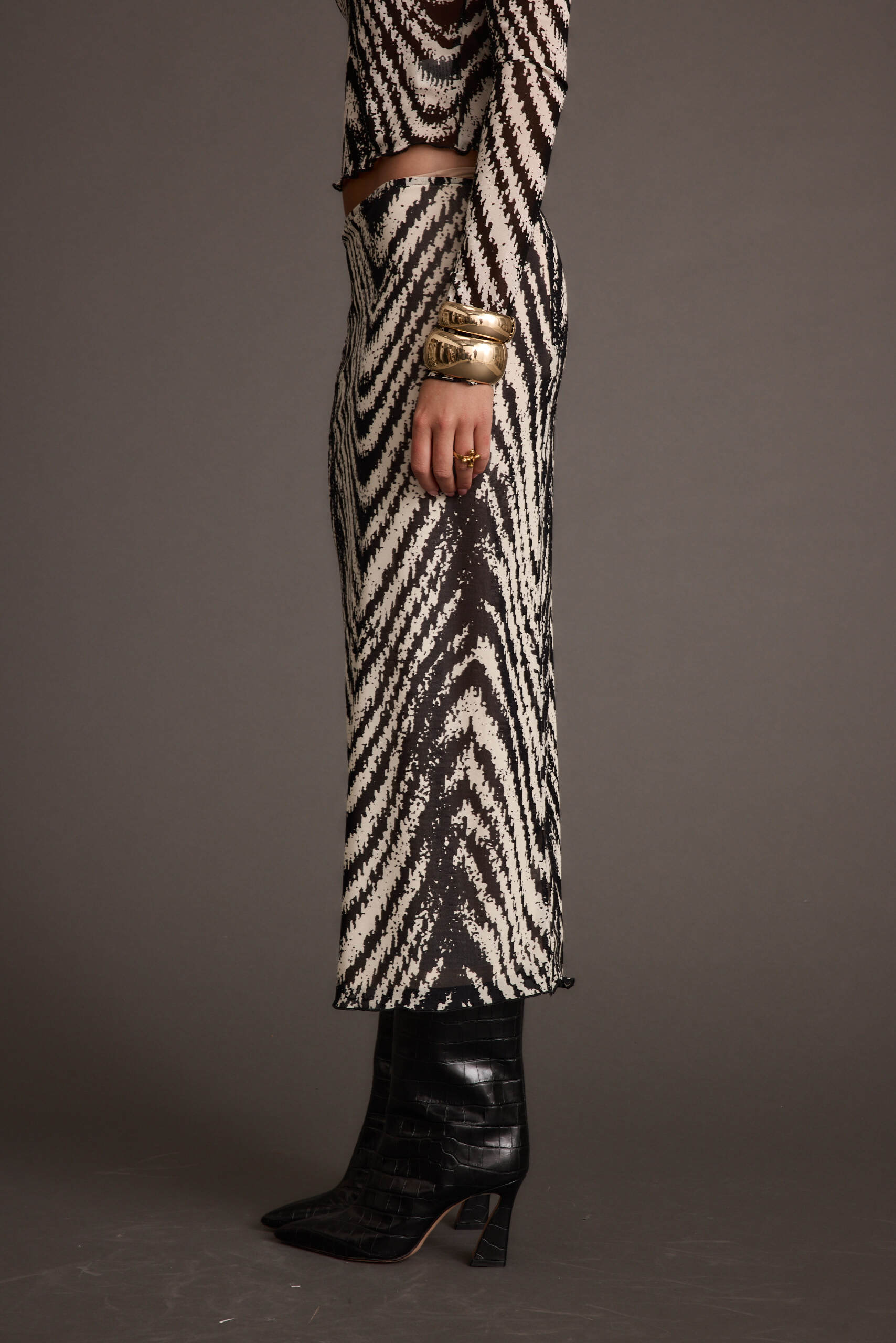 Lifestyle shot of the gold piece styled for day-to-night versatility.