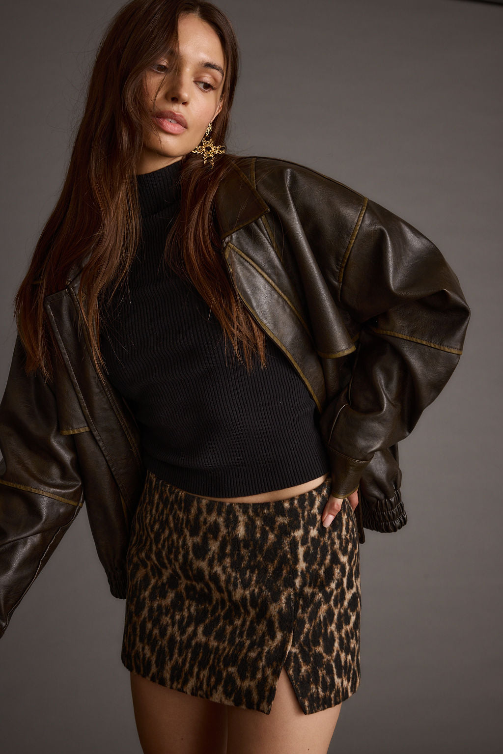 Lifestyle shot of the leopard print mini skirt styled for day-to-night versatility.
