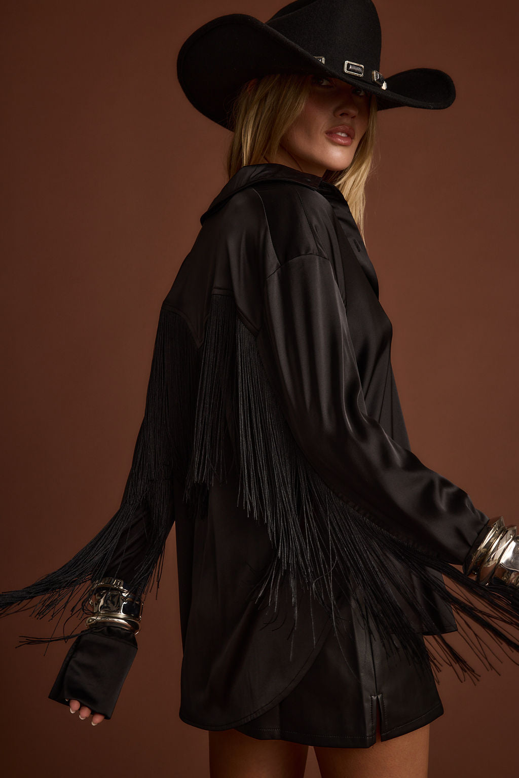 Back view of the black fringe top showing the silhouette and fit.