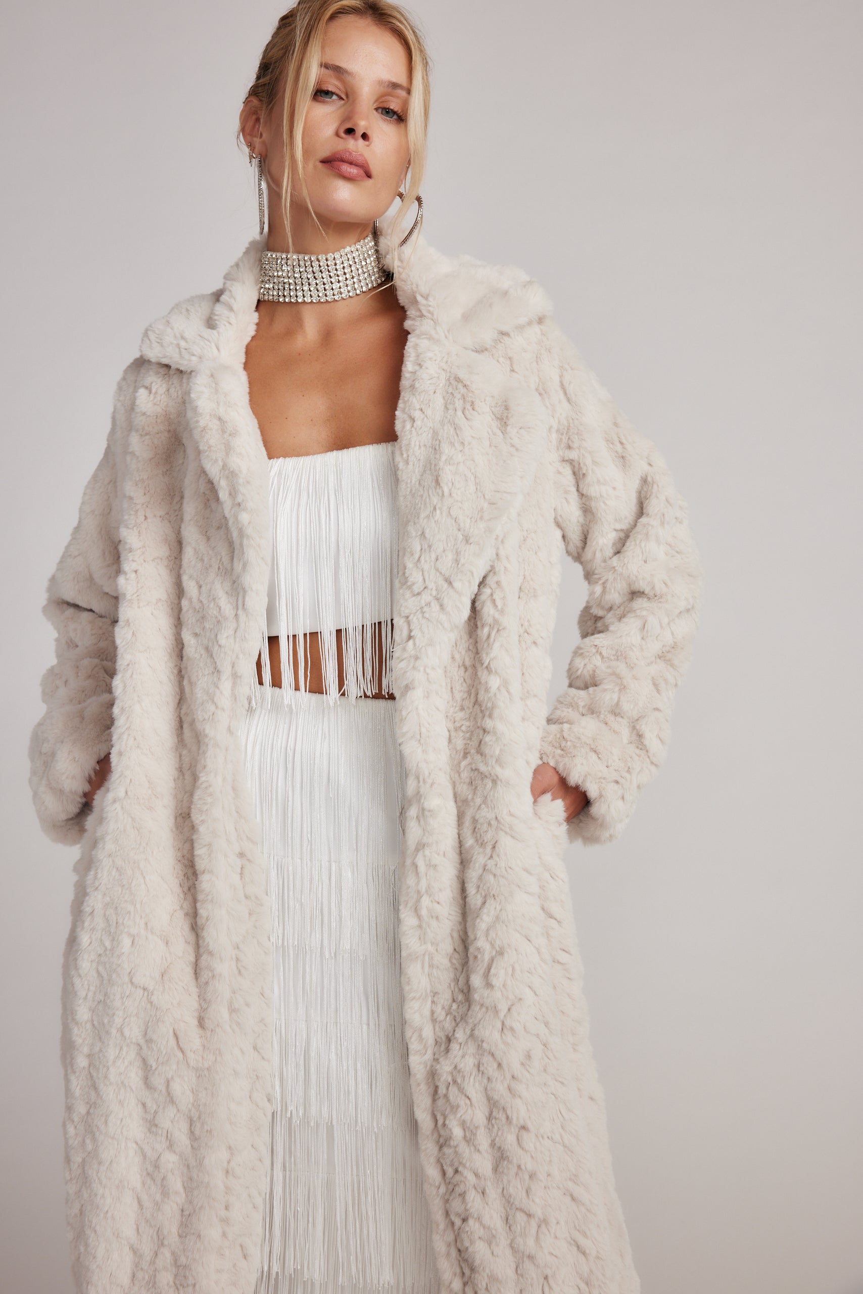 Detail shot of the Sasha Cream Floor Length Coat highlighting the design elements.