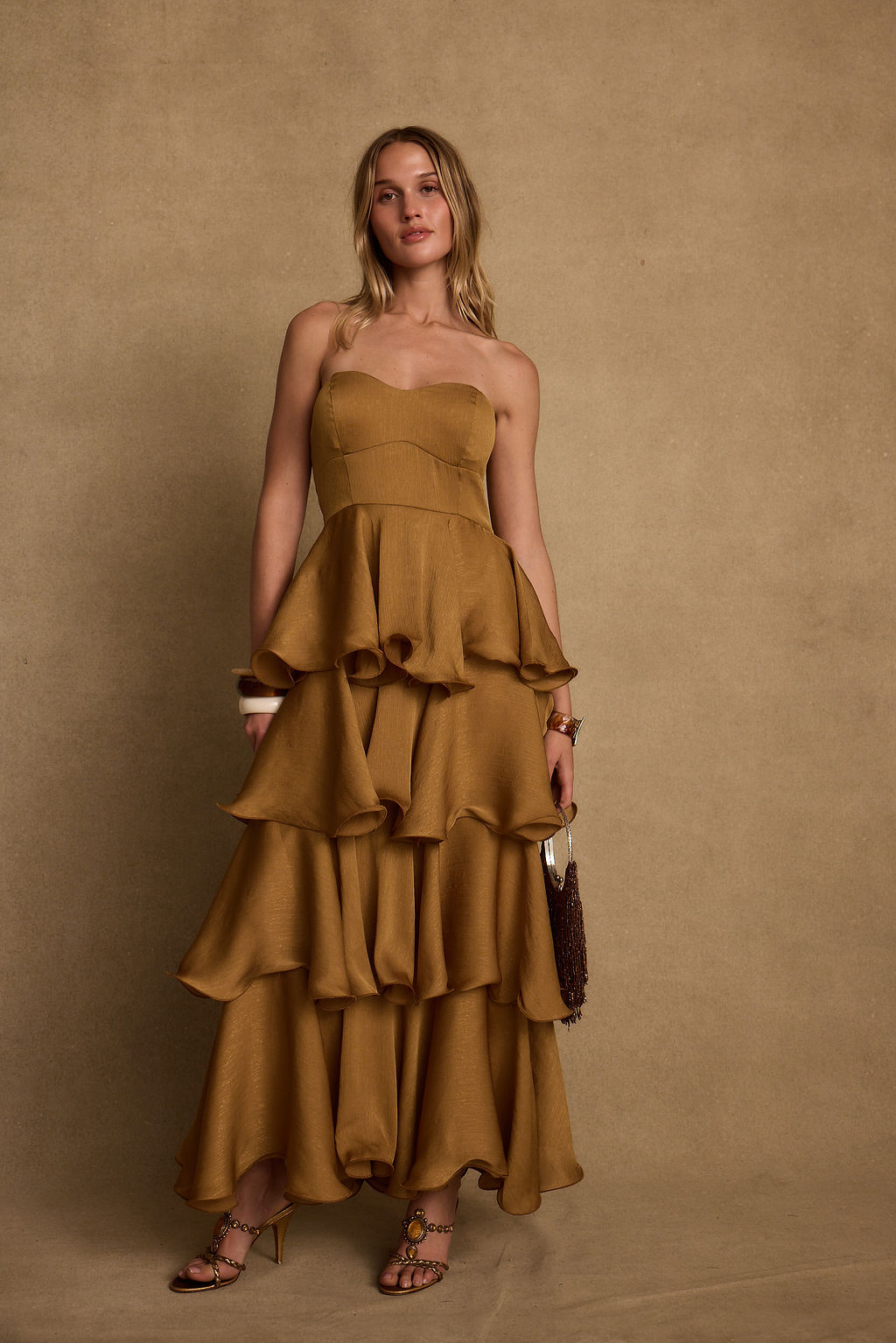 Detail shot of the Selene Gold Ruffle Maxi Dress highlighting the ruffled elements.