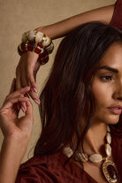 Model wearing the 12th Tribe Soreya Resin and Gold Bangles, the lightweight, gold accented beauties styled with the Cressida Pendant Necklace.