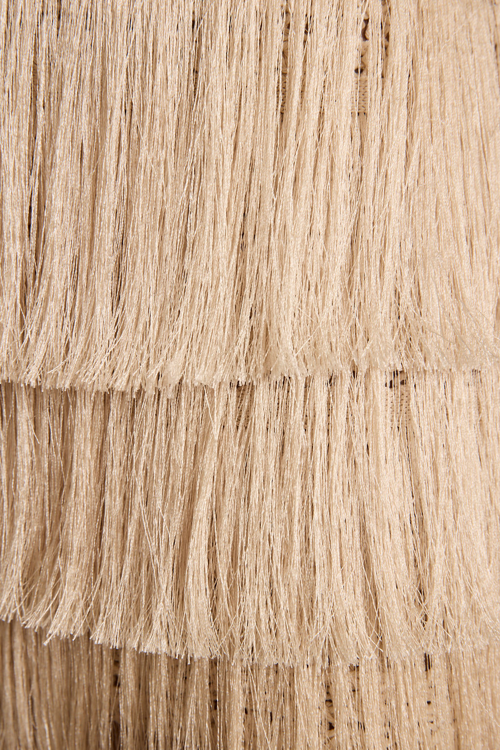 Cream and tan tiered fringe skirt with layered horizontal rows of hanging fringe detail