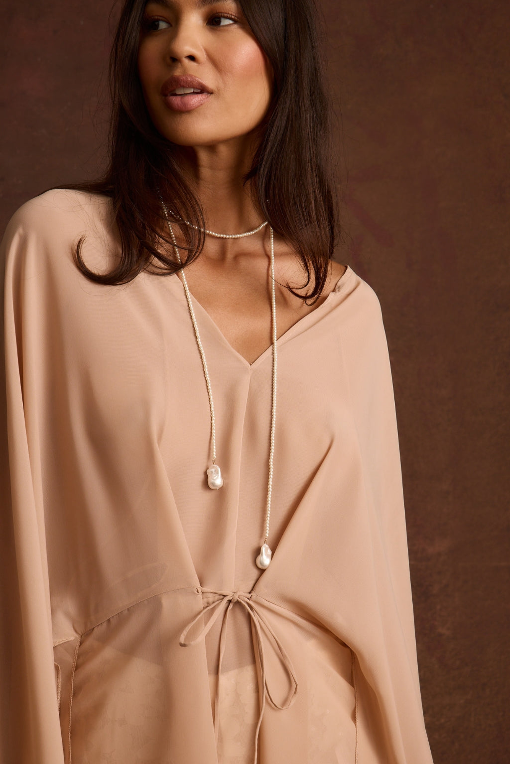 Layered pearl necklace featuring a short beaded choker and a long lariat strand with a baroque pearl drop.
