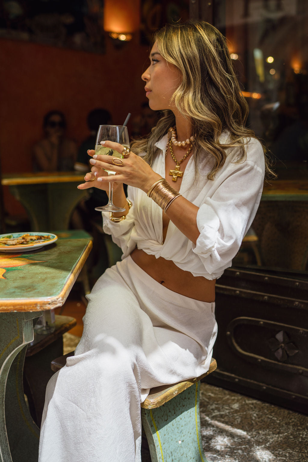 White top with elegant accents, a white feather top essential.