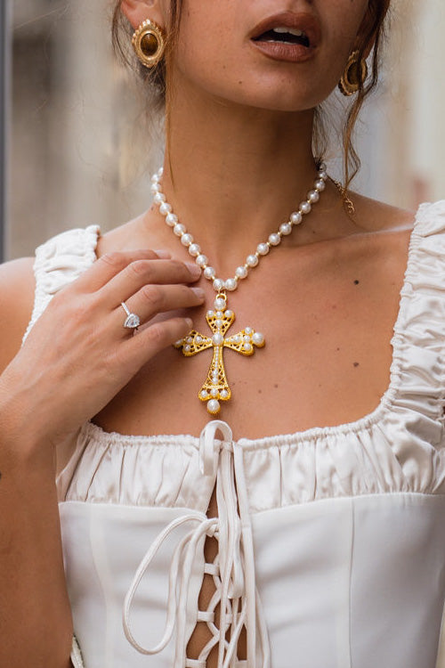 Santina Pearl and Gold Statement Cross Necklace shown from a different angle, highlighting the pearl details.