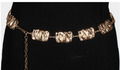 Gold warped square chain belt linked together and fastened over black fabric.