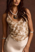 Model wearing the 12th Tribe Seaton Shell Payette Tank in soft ivory, featuring a shell-inspired sequin design and adjustable spaghetti straps, styled with high-waisted jeans and strappy sandals for brunch, festivals, and evening outings