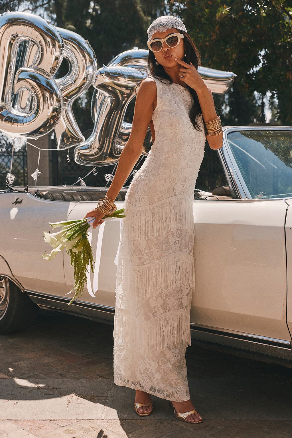 White floral lace maxi dress with a high neckline and tiered fringe skirt, shown from the front.