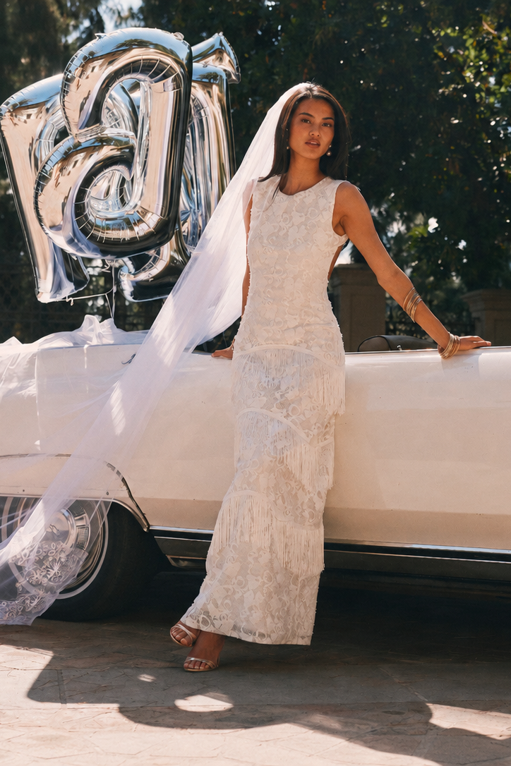 White lace sleeveless maxi dress with tiered fringe detailing, shown from the front.