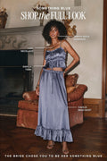 Shop the Something Blue bridal look: woman in a blue satin crop top and maxi skirt set with Zenith gold earrings and Lani necklace