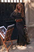 Sweater dress in charcoal with off-shoulder neckline, styled outdoors with cognac studded belt