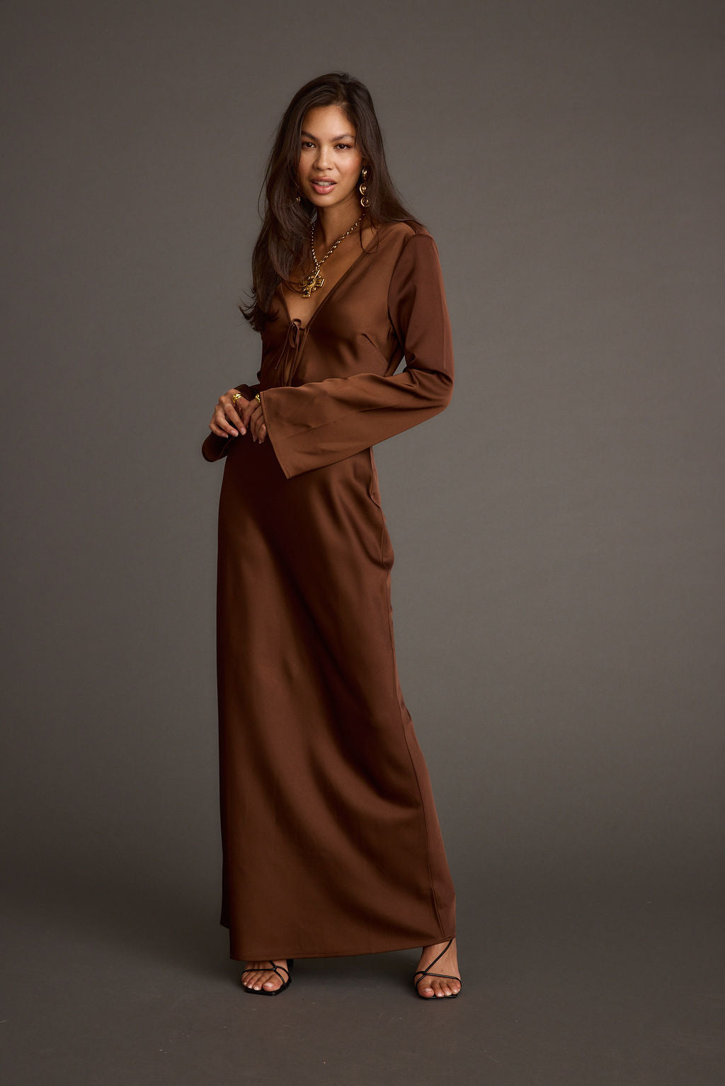 Close-up of the Strokes Mocha Long Sleeve Plunge Satin Maxi Dress showcasing the satin texture and craftsmanship.