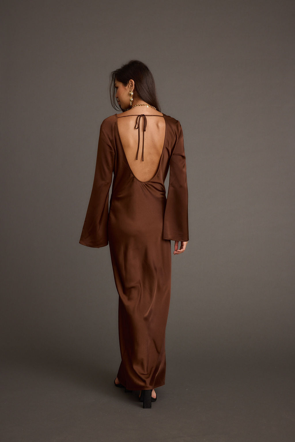 Lifestyle shot of the mocha maxi dress styled for day-to-night versatility.
