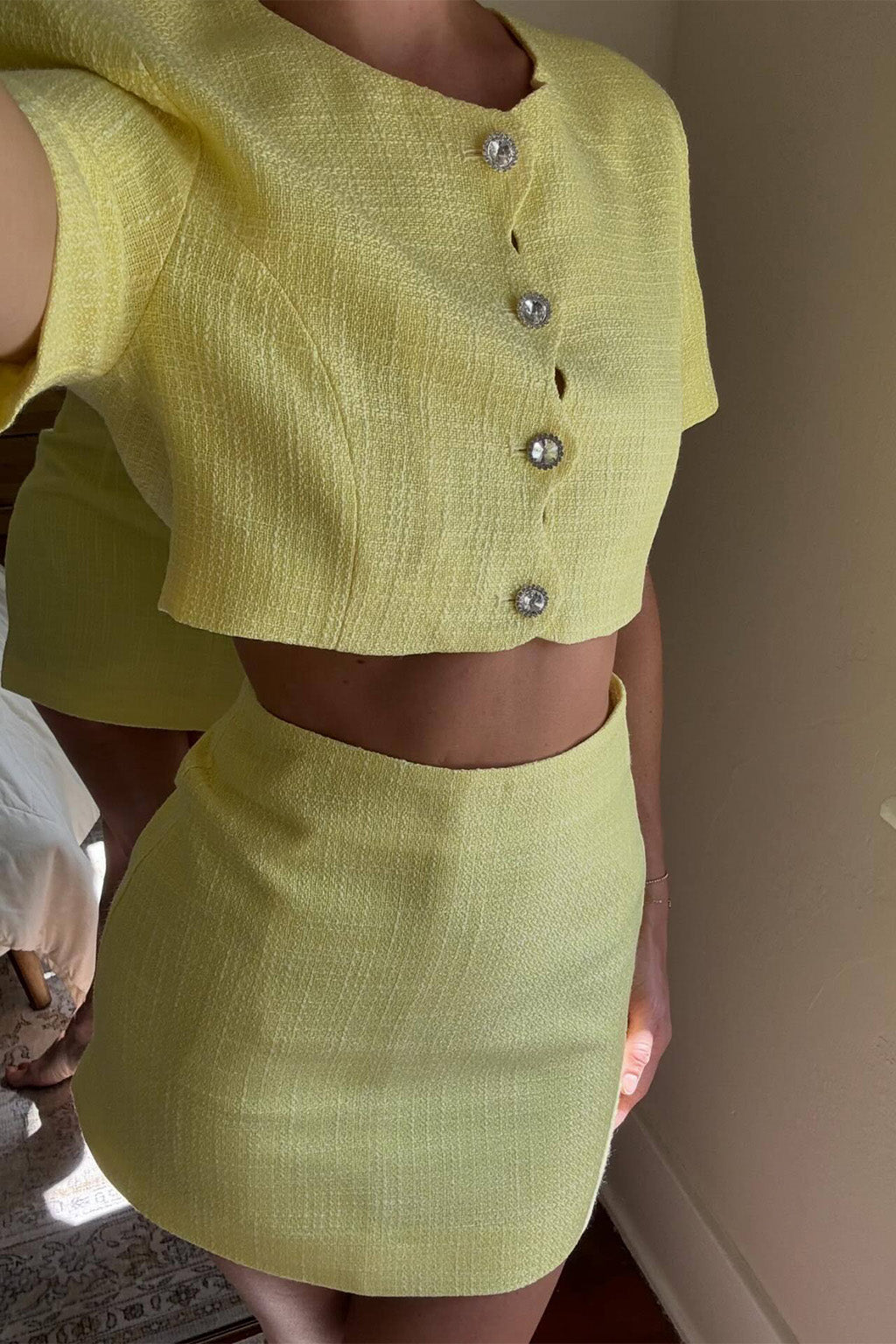 Yellow mini skirt with elegant accents, a yellow maxi skirt essential.