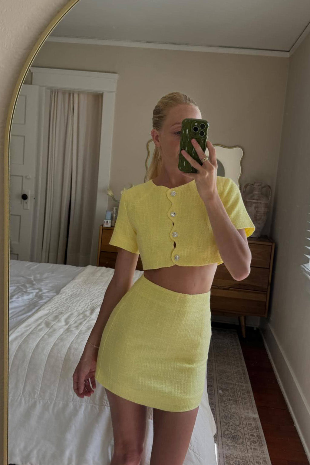Close-up of the Sunday Yellow Mini Skirt showcasing the fabric texture and design details.