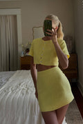 Back view of the yellow mini skirt showing the silhouette and fit.