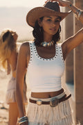 Model wearing the 12th Tribe Shay White Grommet Tank, a mid-length ribbed tank featuring grommet stud detailing around the neckline and armholes, the perfect fashion basic for pairing with skirts, shorts, or trousers for summer soirées, festival-ready looks, and stylish warm-weather outfits.