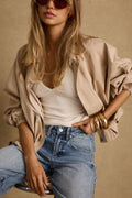 Khaki jacket with refined detailing and a flattering silhouette.