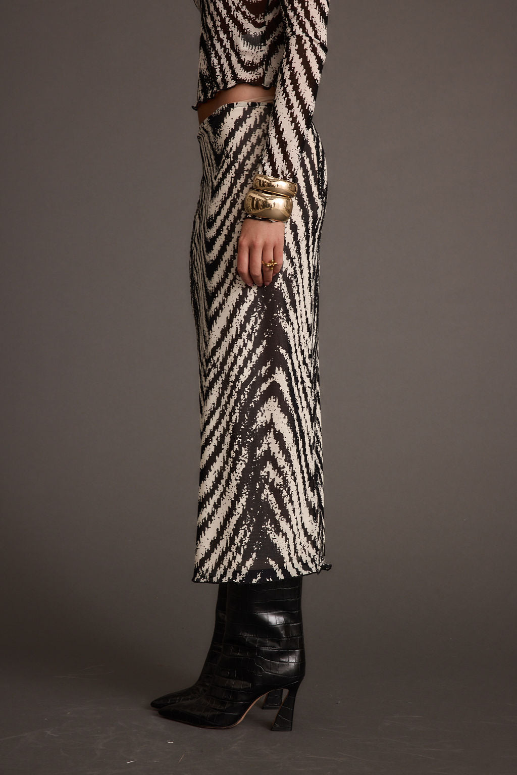 Detail shot of the Taryn Zebra Mesh Midi Skirt highlighting the mesh elements.