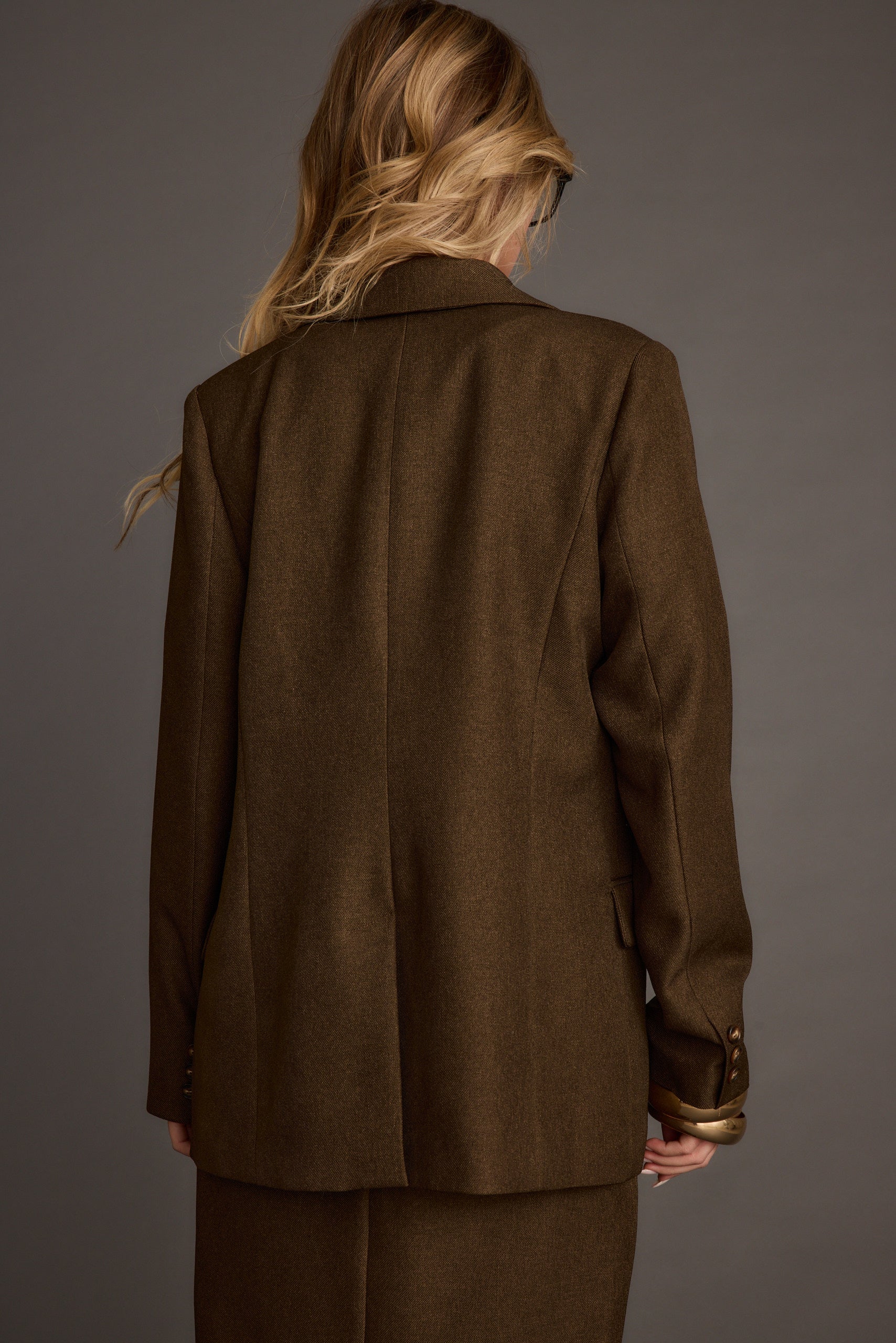 Lifestyle shot of the mocha blazer styled for day-to-night versatility.