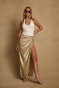 Gold metallic maxi skirt with refined detailing and a flattering silhouette.