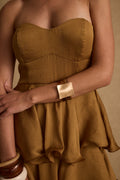 Gold piece with refined detailing and a flattering silhouette.