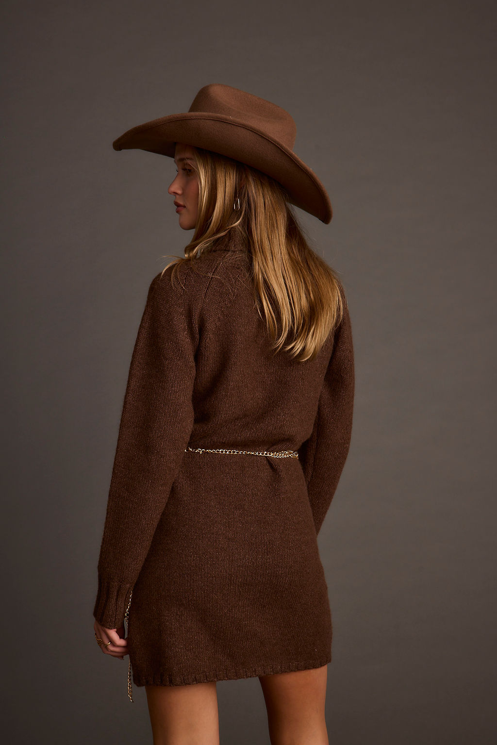 Lifestyle shot of the mocha mini dress styled for day-to-night versatility.