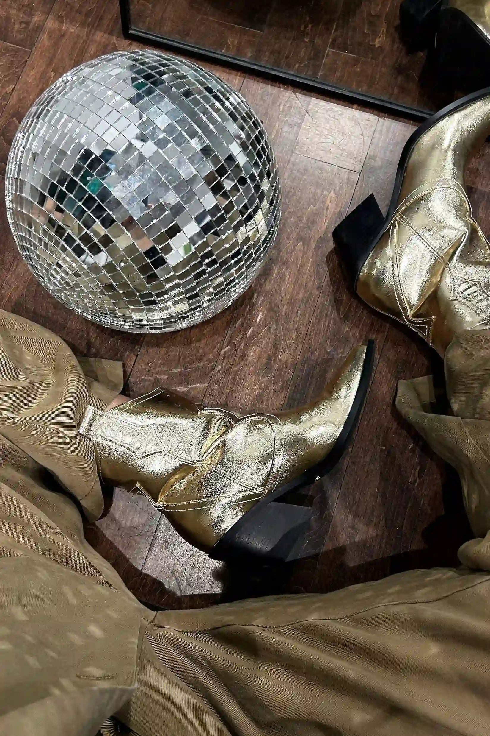 Back view of the gold metallic boots showing the silhouette and fit.