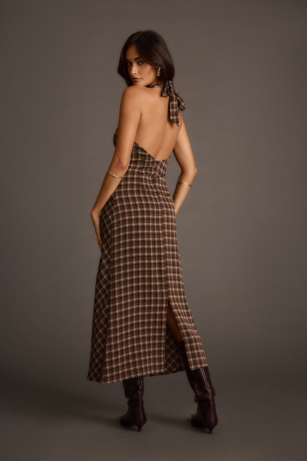 Back view of an espresso satin midi dress with an open back and side slit