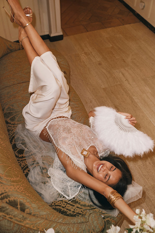 Cream satin dress with a sheer beaded lace overlay and delicate lace trim.