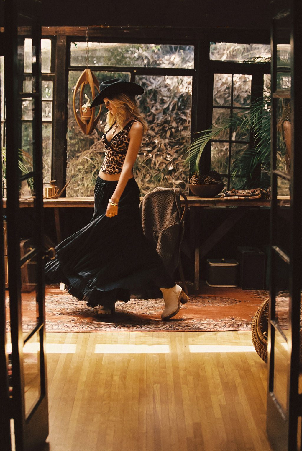 Full-length view of the black maxi skirt showing the drape and movement.
