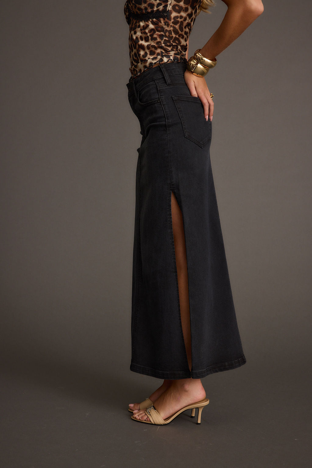 Detail shot of the Wilder Black Stretch Denim Maxi Skirt highlighting the denim elements.