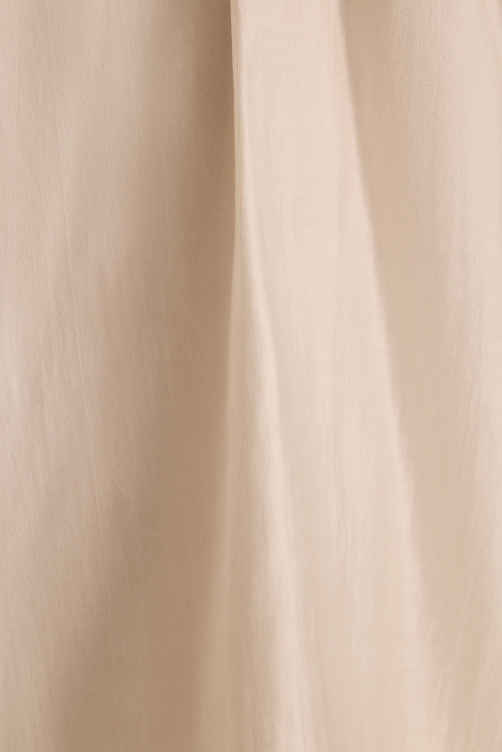 Close-up of the Zella halter top's ivory fabric draping in soft vertical folds.