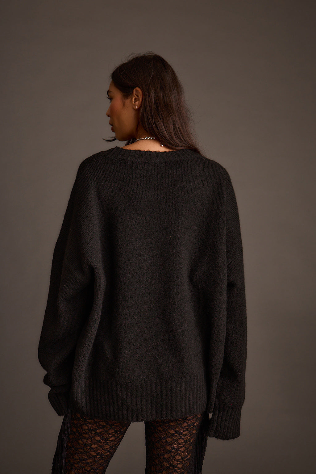 Back view of a black oversized sweater showing its relaxed, slouchy fit