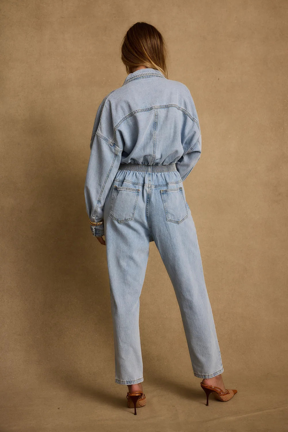 Detail shot of the Hendrix Denim Jumpsuit highlighting the denim elements.