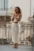 Cream knit midi skirt with knit detailing and a flattering silhouette.